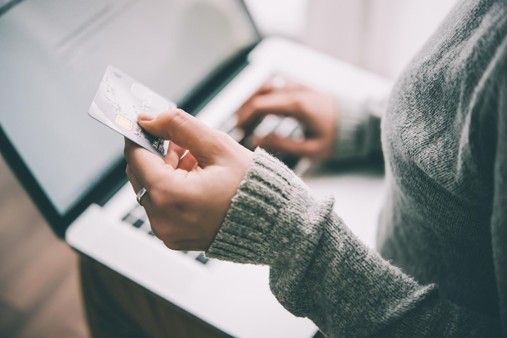 Person using credit card to purchase online.